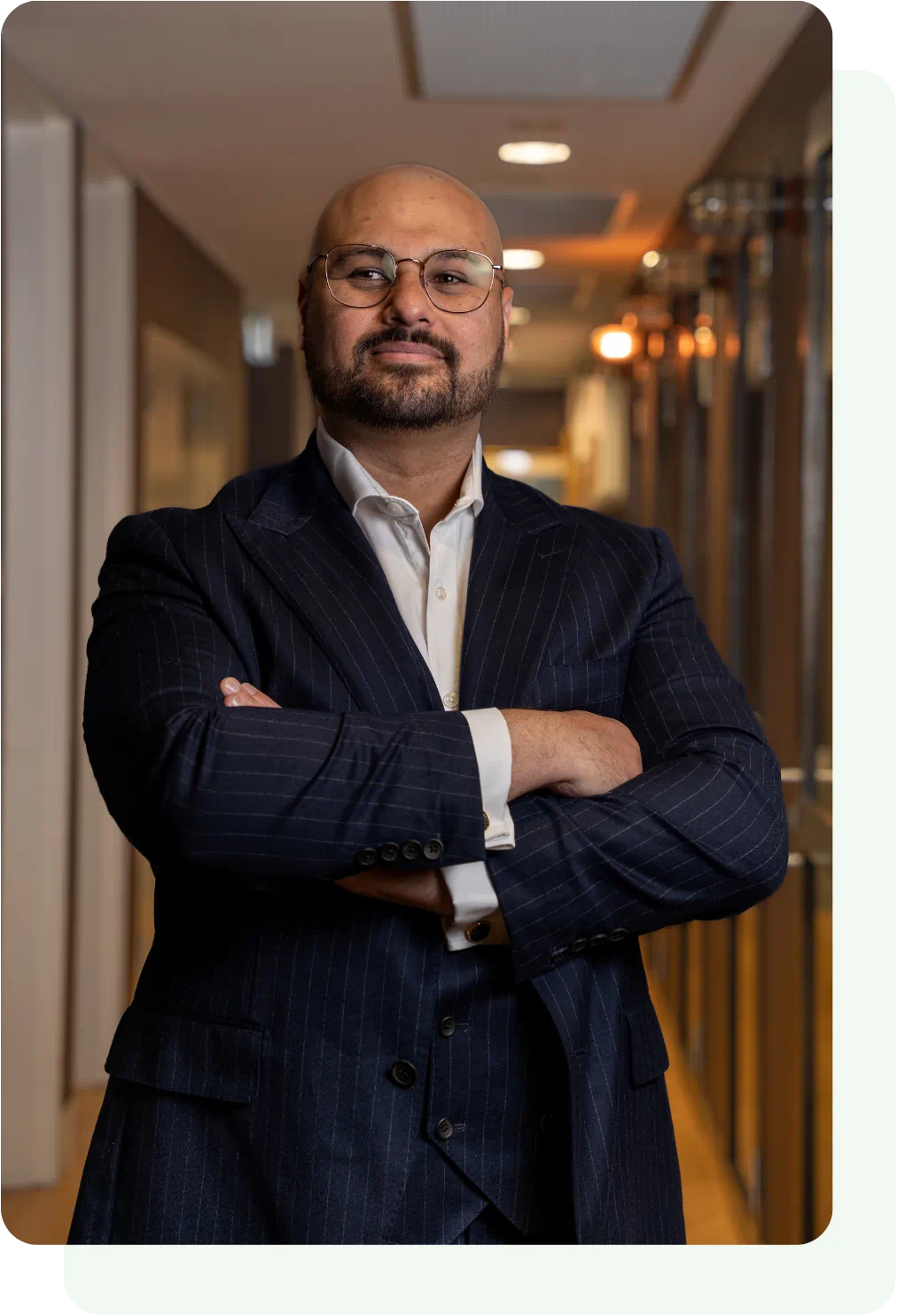 Professional man posing confidently in a corridor.